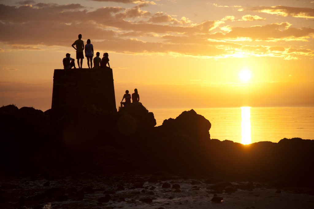 Sunset shot of students looking out towards the horizon