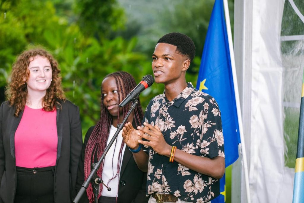 Students delivering a speech on stage. Community and role models